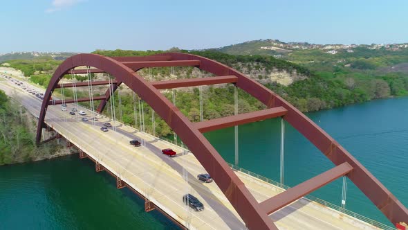 Traffic jam slowly moving across the Pennybacker bridge. Aerial footage is moving counter clock-wise alt
