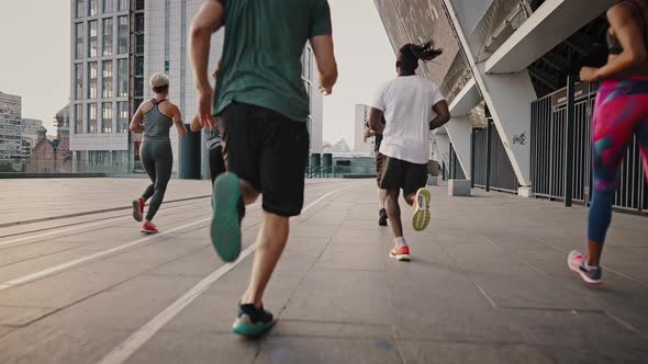 Big Team of Athletes Has a Group Training Session on the Urban Streets of a Big City alt
