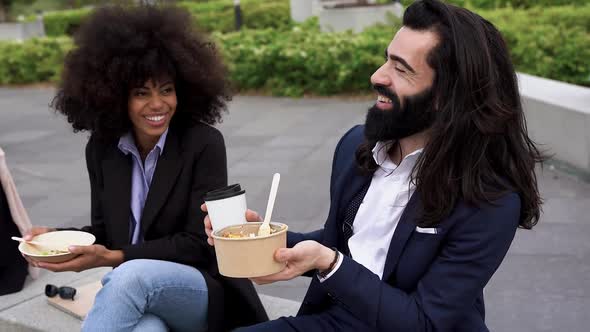 Multiracial business people eating together outdoor healthy poke food