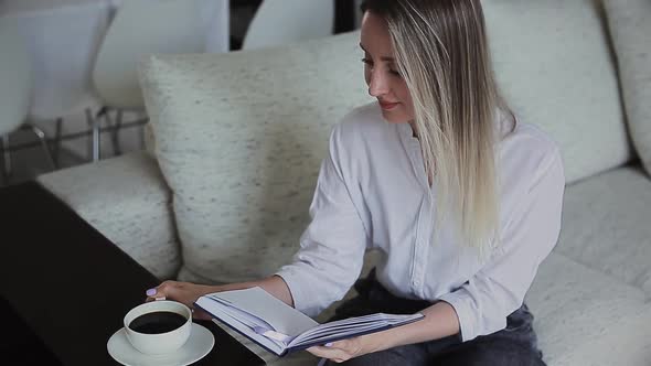 Beautiful Girl Reading and Drinking Coffee