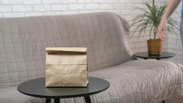 Woman Puts Take Away Bag alt