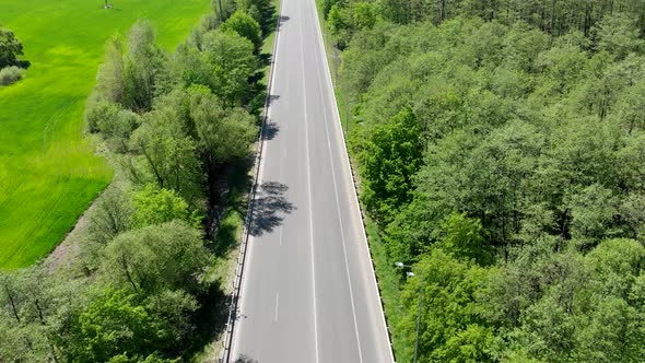 Empty Road Without Cars. The Highway Goes Through Fields and Forests Without Passing Cars.