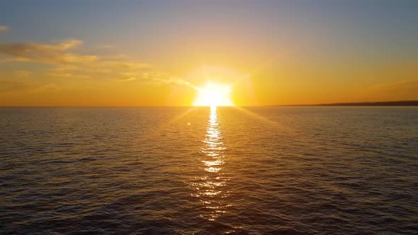 aerial red sunsets over sea video 4K. The sun touches horizon.Red sky, yellow sun and amazing sea 4K