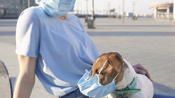 Woman and Dog in Their Face Masks and At the City Square