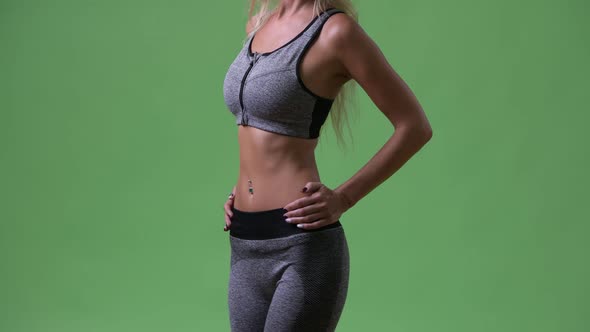 Young Woman Showing Fit and Healthy Body for Gym Concept