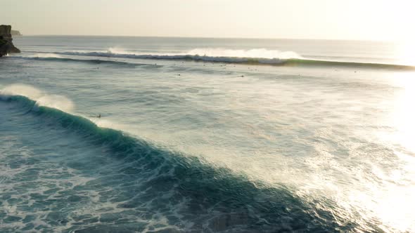 Following large waves at sunset