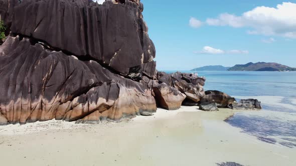 big rocks and a yacht on the coast of Seychelles