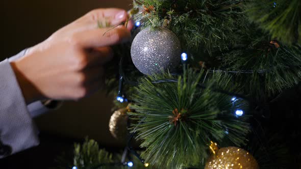 Christmas Time and Happy New Year Symbols. Woman Decorating Christmas Tree with Balls and Toys alt