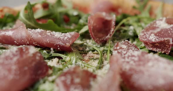 Close Up Pizza with Prosciutto Parma Ham Arugula Salad Rocket with Ingredients alt