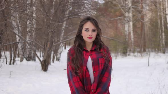 Charming Female with Long Hair Walking in Snowy Forest