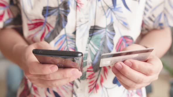 Man Hand Holding Smartphone And Credit Card And Doing Online Shopping At Home. Banking alt