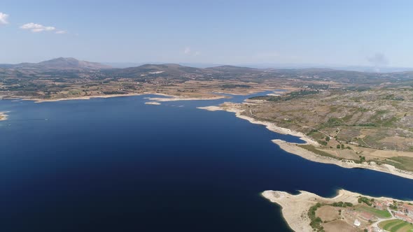 Blue lake and grassland in a sunny day alt