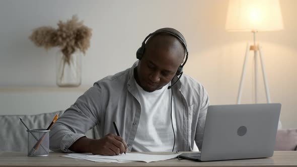 African Mature Student Guy Learning At Laptop Online At Home alt