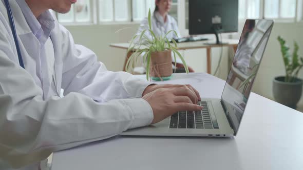 Close Up Man Doctor Is Using Laptop Computer In Workplace. Medical Concept alt