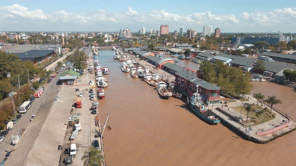 Aerial establishing shot rising over Puerto de Frutos in Tigre city near Buenos Aires alt