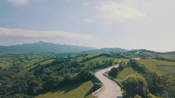 Cinematic aerial drone video of a roadline into a picturesque mountain view of Batanes in the Philip alt