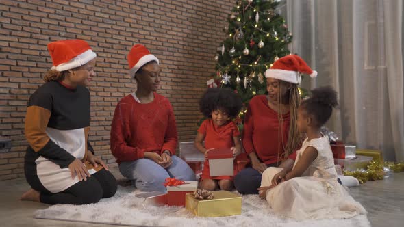 African American black family, women and kid girl daughters sharing gifts on Merry Christmas alt