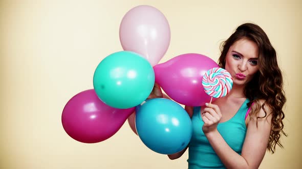 Girl with Balloons and Lollipop Candy