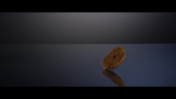 Falling cookies from above onto a reflective surface  alt