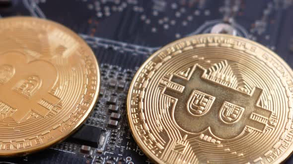 Cryptocurrency mining theme. Close up of bitcoin motherboard graphics card rotate. alt