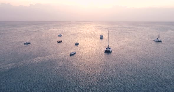 Yachts and Fishing Boats in Blue Sea at Sunset in Summer