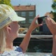 A Woman Takes Pictures of Copenhagen's City Line Sails on a Sightseeing Boat - VideoHive Item for Sale