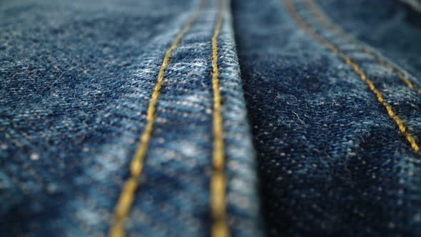 Extreme Detailed of Blue Denim Jeans Texture in Dolly Shot Over Cloth Surface alt