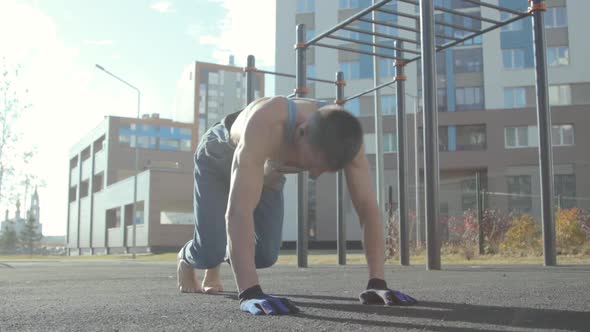 A man exercising on a sports ground