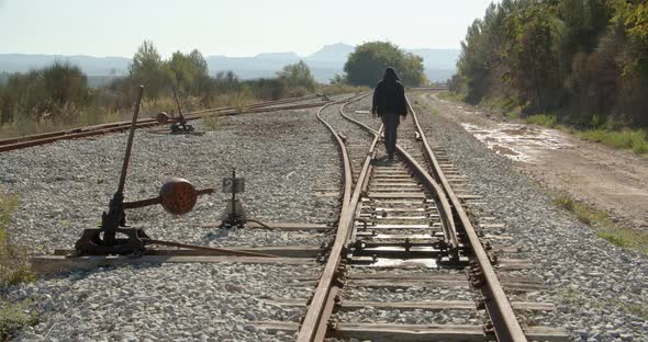 Man Walks Away By The Railway