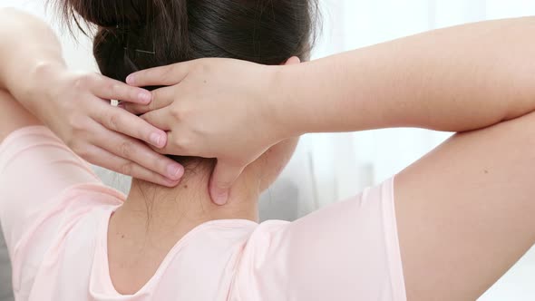 Close up of tired woman massaging rubbing stiff sore neck tensed muscles fatigued from work in incor alt