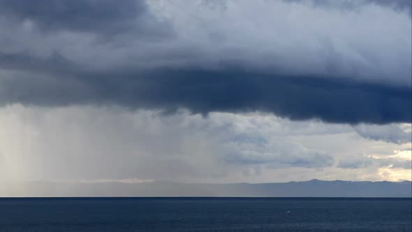 Stormy Clouds Over Calm Blue Sea