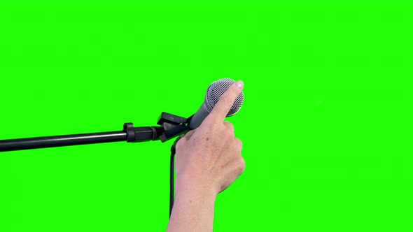 A Microphone Cut Out on Green Chroma Background. Close Up. 4K.