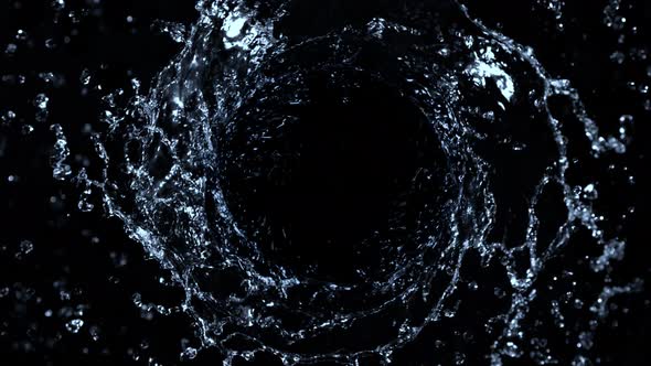 Super Slow Motion Shot of Rotating Water Splash Isolated on Black Background at 1000Fps alt
