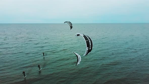 Aerial Drone View of a Corekites Kitesurfers Hydrofoiling  in Engure Port at in Baltic Sea alt