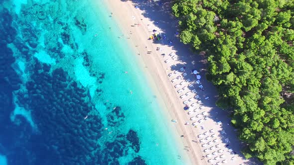 Flying over of the sandy beach Zlatni rat on the island of Brac, Croatia alt
