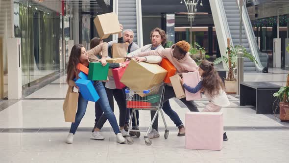 Group of Shopaholics With Shopping Bags Are Pushing at Store. Crazy Shopping at Big Sales. alt