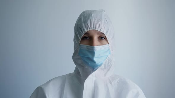 Tired Female Doctor Takes Off His Glasses and Mask After Hard Working Day Receiving Sick Patients alt