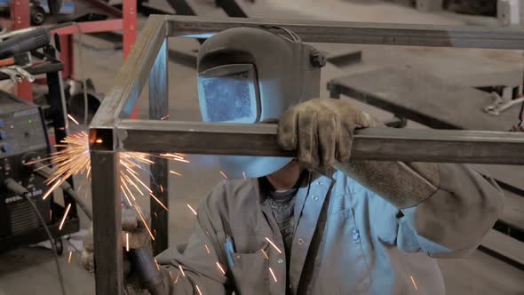 Welder Worker Hand Welds Metal Constructions. Workman In Workshop.
