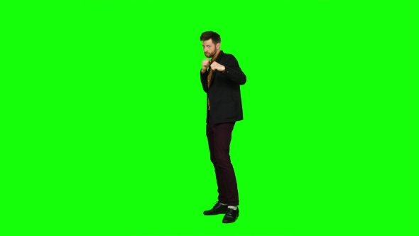 Man Is Standing in a Rack and Boxing. Green Screen alt