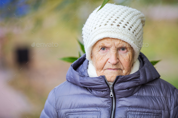 Portrait of an aged woman outdoors