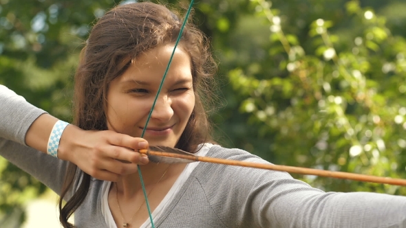 Woman Making Funny Face After Shooting an Arrow, Stock Footage | VideoHive