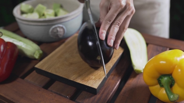 VideoHive The Cook Cuts the Eggplant on the Wooden Board Outside for Making Vegetarian Meal Vegetable Cuisine 20314784 VideoHive The Cook Cuts the Eggplant on the Wooden Board Outside for Making Vegetarian Meal Vegetable Cuisine 20314784