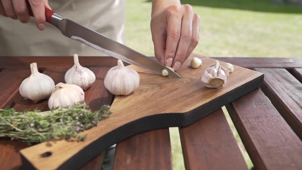 VideoHive The Cook Slices Garlic on the Wooden Board By Sharp Knife Outside Cooking Outside Cooking Healthy 20314824 VideoHive The Cook Slices Garlic on the Wooden Board By Sharp Knife Outside Cooking Outside Cooking Healthy 20314824