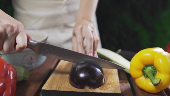 VideoHive The Cook Cuts the Eggplant on the Wooden Board Outside for Making Vegetarian Meal Vegetable Cuisine 20314833 VideoHive The Cook Cuts the Eggplant on the Wooden Board Outside for Making Vegetarian Meal Vegetable Cuisine 20314833