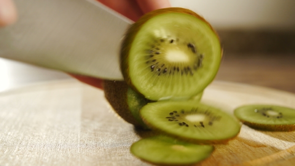 Man Slicing Kiwi Fruit