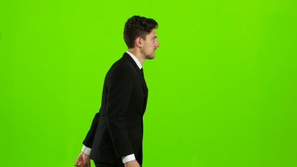 Man Holds a Briefcase in His Hand, He Rushes Over It. Green Screen alt