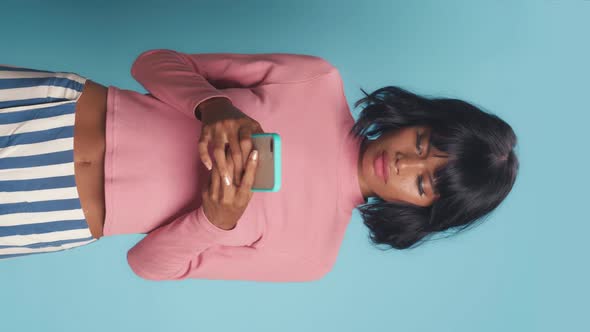 Vertical Video of Woman Thinks Deeply About Something Uses Phone alt