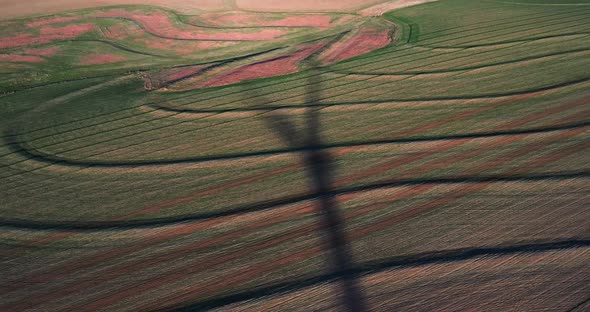 Shadow of aing wind turbine recorded with drone. alt