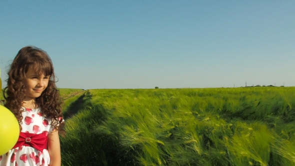 Little Girl with Balloons in a Field of Wheat, Stock Footage | VideoHive