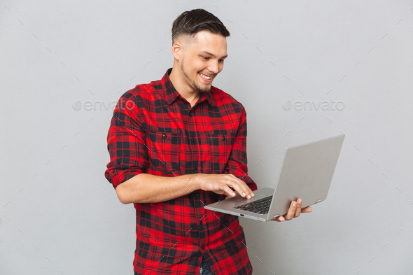 Happy man using laptop computer